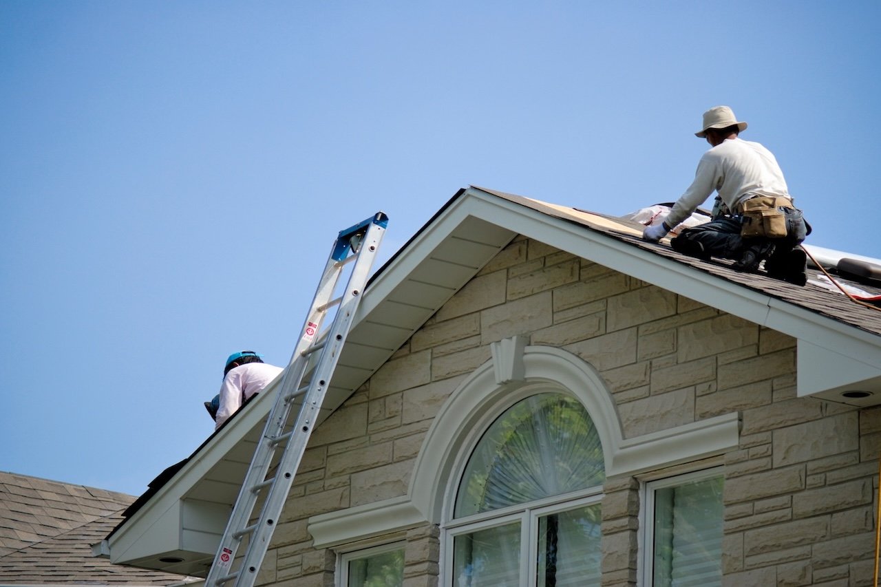 roofing-contractors-working-residential-house-with-blue-sky-background